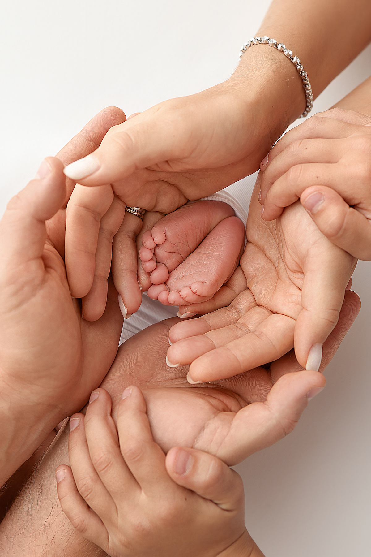 Children's foot in the hands of mother, father, parents. Feet of a tiny newborn close up. Little baby legs. Mom and her child. Happy family concept. Beautiful concept image of motherhood stock photo.