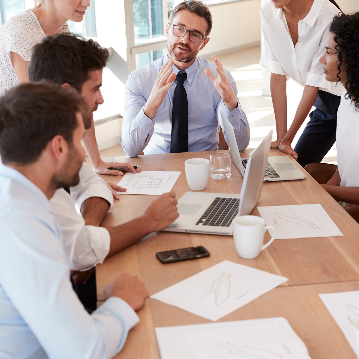 Group Of Businesspeople Meeting Around Table In Office